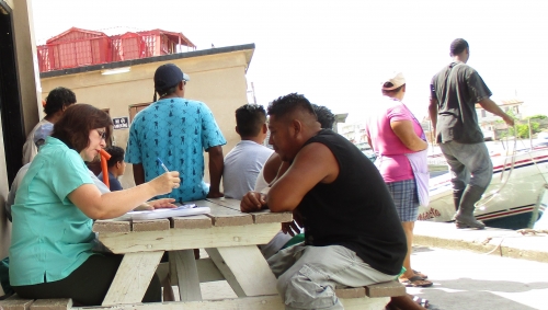 Claudia Stella Beltr&aacute;n Turriago, economic consultant, interviewing fishers at Northern Fishermen's Cooperative in Belize City, Belize